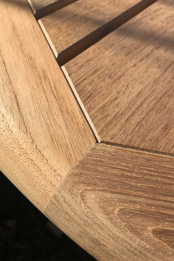 close up of the woodwork on a Harlow & Macgregor round table with umbrella hole